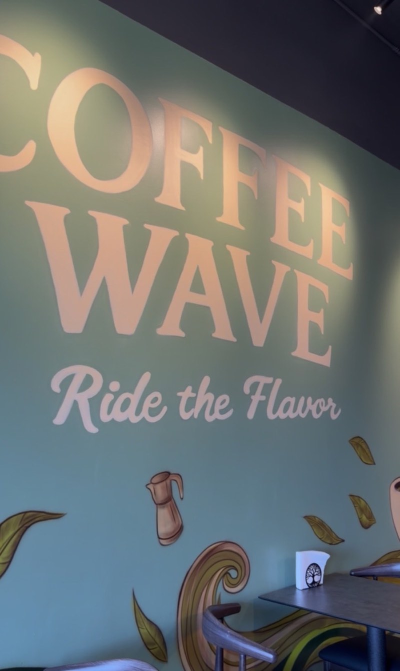 Coffee Wave's sage mural with the words Ride the Flavor